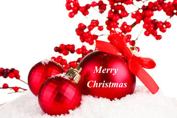 Beautiful red Christmas balls on snow, isolated on white