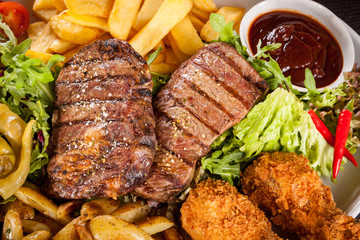 Platter of mixed meats, salad and French fries