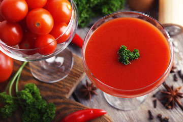 Tomato juice in goblet and fresh vegetables
