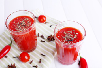 Tomato juice in glasses and fresh vegetables