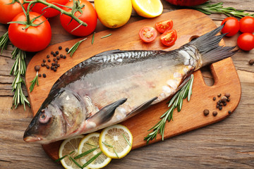 Fresh raw fish and food ingredients on table