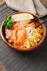 Bowl of boiled rice and fresh salted salmon