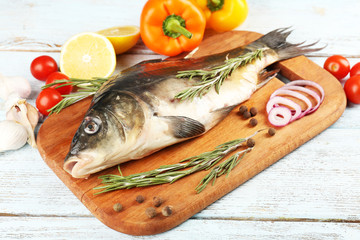 Fresh raw fish and food ingredients on table