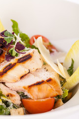 tasty fresh caesar salad with grilled chicken and parmesan