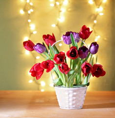 tulips on a wooden board in front of bokeh. good for mother's day