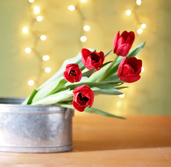 tulips on a wooden board in front of bokeh. good for mother's day