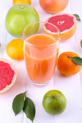 Naklejka na ściany i meble Juice and many citrus on table close-up