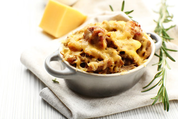 Pasta baked with vegetables and cheese in ceramic pot