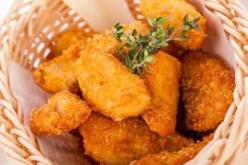Crumbed chicken nuggets in a basket
