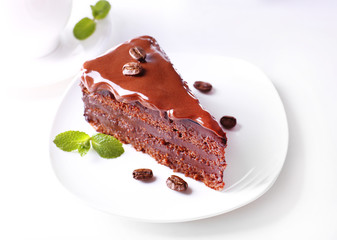 Delicious chocolate cake on plate on table on light background