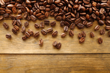 Coffee beans on wooden background, close-up