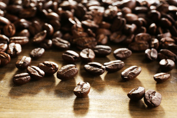 Coffee beans on wooden background, close-up