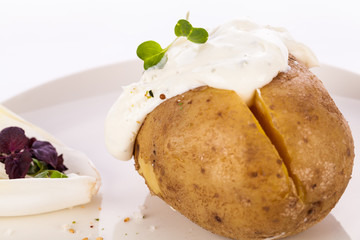 Baked jacket potato with sour cream sauce