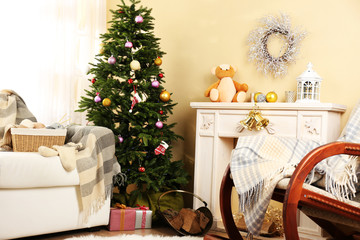Beautiful Christmas interior with decorative fireplace and fir
