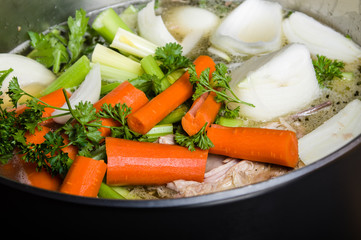 Stock pot with cut vegetables for soup