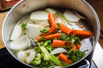 Stock pot with cut vegetables for soup