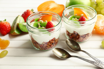 Healthy dessert with muesli and fruits on table