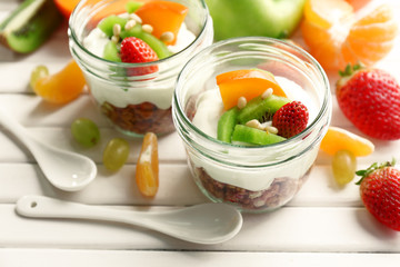 Healthy dessert with muesli and fruits on table