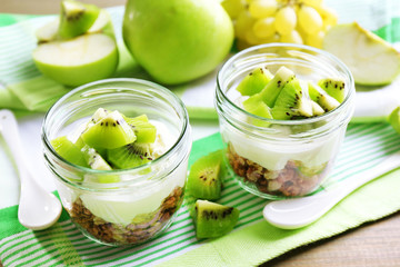 Healthy dessert with muesli and fruits on table