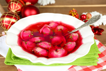 Traditional polish clear red borscht with dumplings and