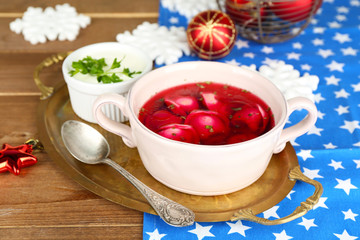 Traditional polish red borscht with dumplings and Christmas
