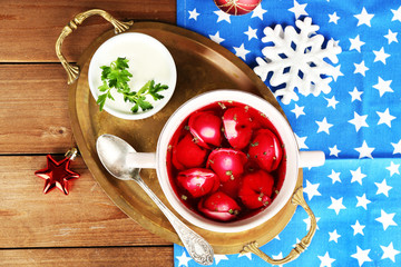 Traditional polish red borscht with dumplings and Christmas