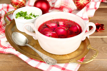 Traditional polish clear red borscht with dumplings in bowl