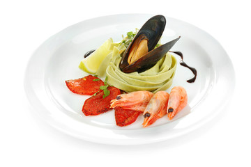 Tasty pasta with shrimps, mussels and tomatoes isolated on