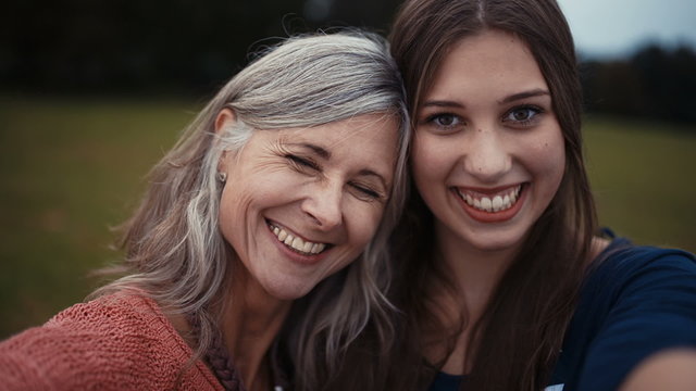 Mother and daughter pose together for a selfie