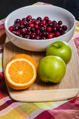 Bowl of cranberries with apples and oranges