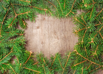 wooden background with space for text with fir branches