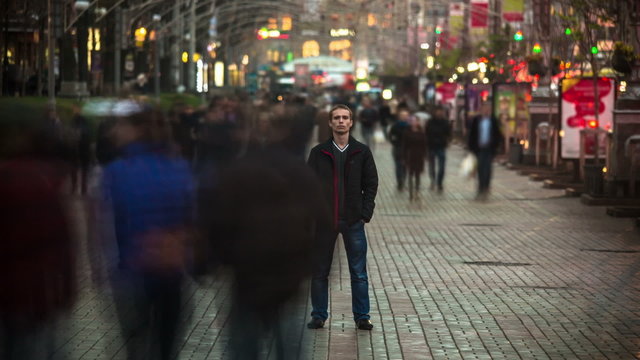 Man stand in the crowd. Time lapse