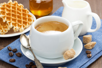 cup of coffee, waffles and honey