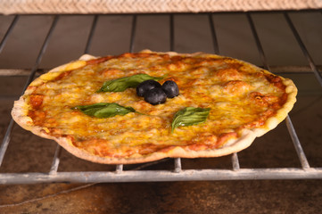 pizza in oven at restaurant kitchen.
