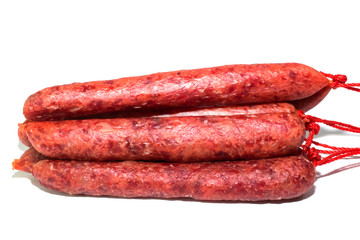 Raw meat sausages isolated on white background