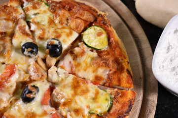 close up of pizza on wooden board.