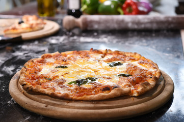 close up of pizza on wooden board.