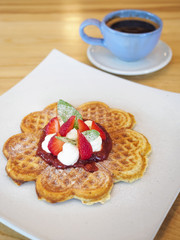 Waffle dessert with strawberry sauce fresh cream coffee