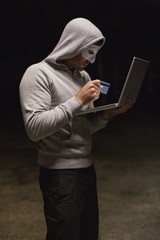 Hacker using laptop to steal identity