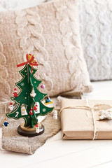 Green new year tree with pillow and present