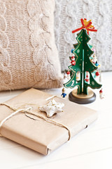 Green new year tree with pillow and present