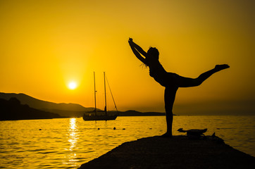 Silhouette woman with yoga posture on the beach