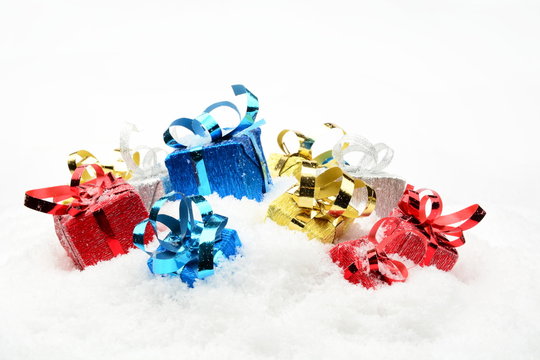 Three blue,red,golden,silver christmas gifts on snow