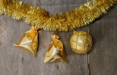 Gifts,  ball, tinsel on the wooden background