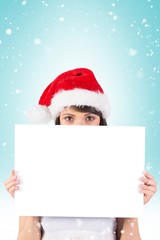 Pretty santa girl smiling at camera with poster