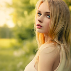 Girl in the park in a white dress closeup potrtait