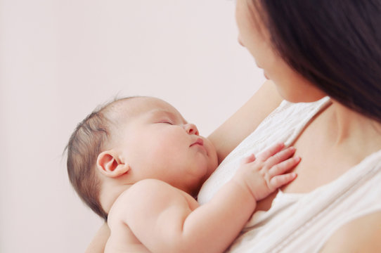 soft image of newborn baby with mother