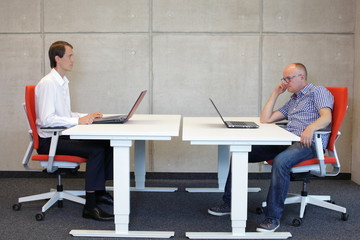 correct and bad sitting position at desk in office