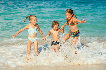 happy kids playing on beach at the day time