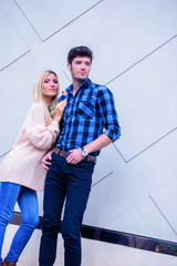 Attractive couple on a wall background